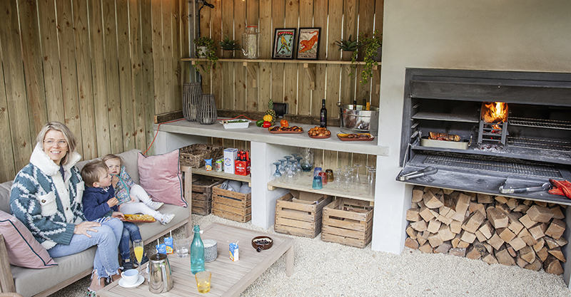 Inviting kitchen garden design by Keltie & Clark, featuring a charming outdoor dining area with rustic wooden elements in the Cotswolds.