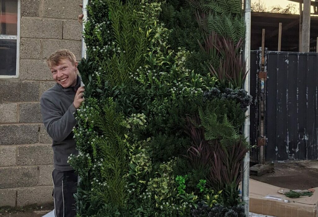 Putting together a vertical garden for a client by Gardens by Keltie & Clark