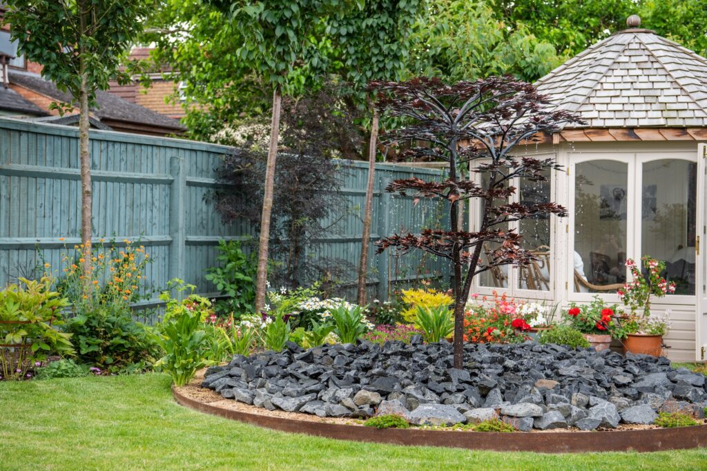 A decorative water features creates a focal point for this luxury garden design in the Cotswolds